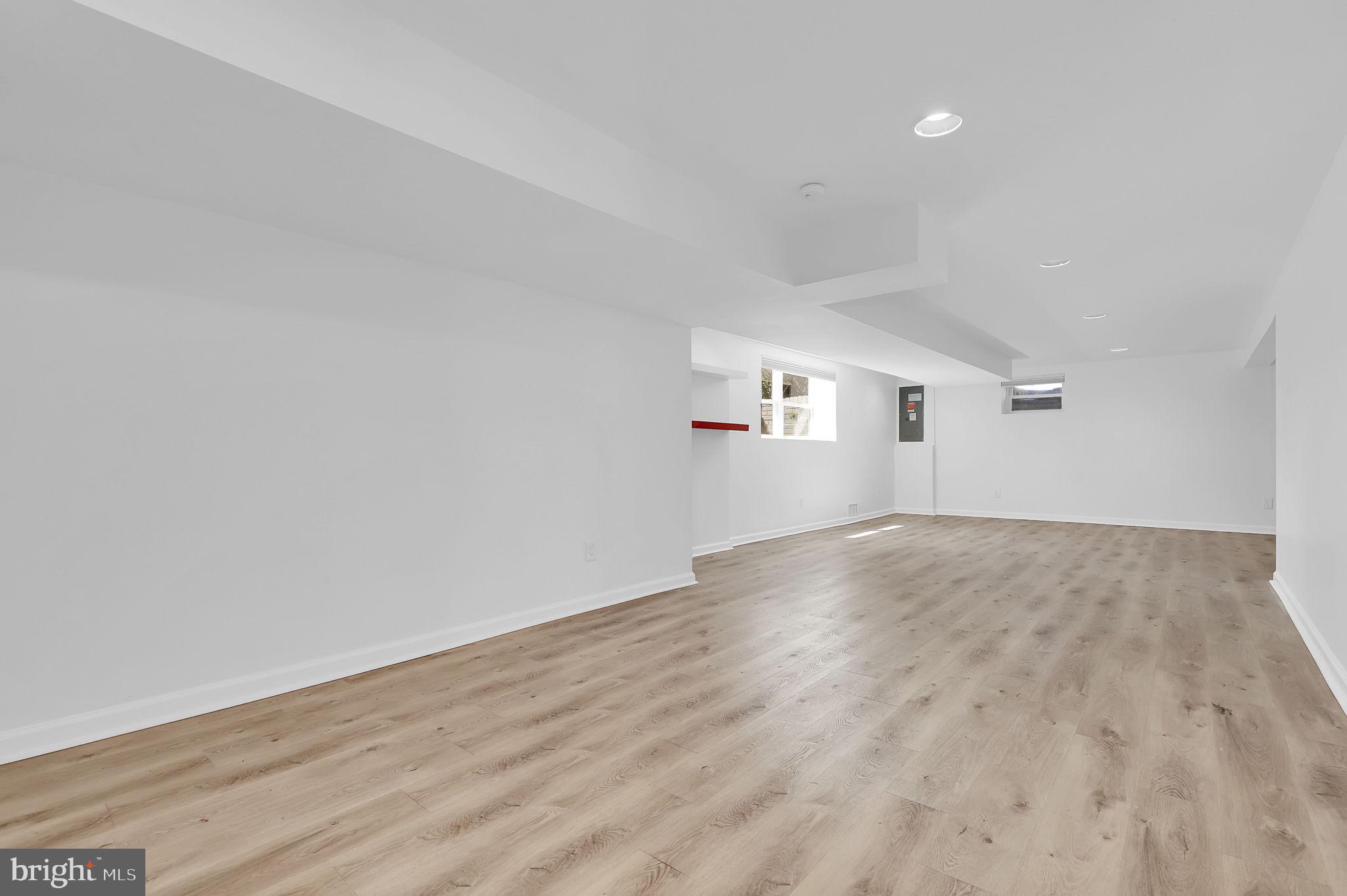 1009 Stirling Road Silver Spring, MD 20901 - Photo 18 of 33 an empty room with wooden floor and windows