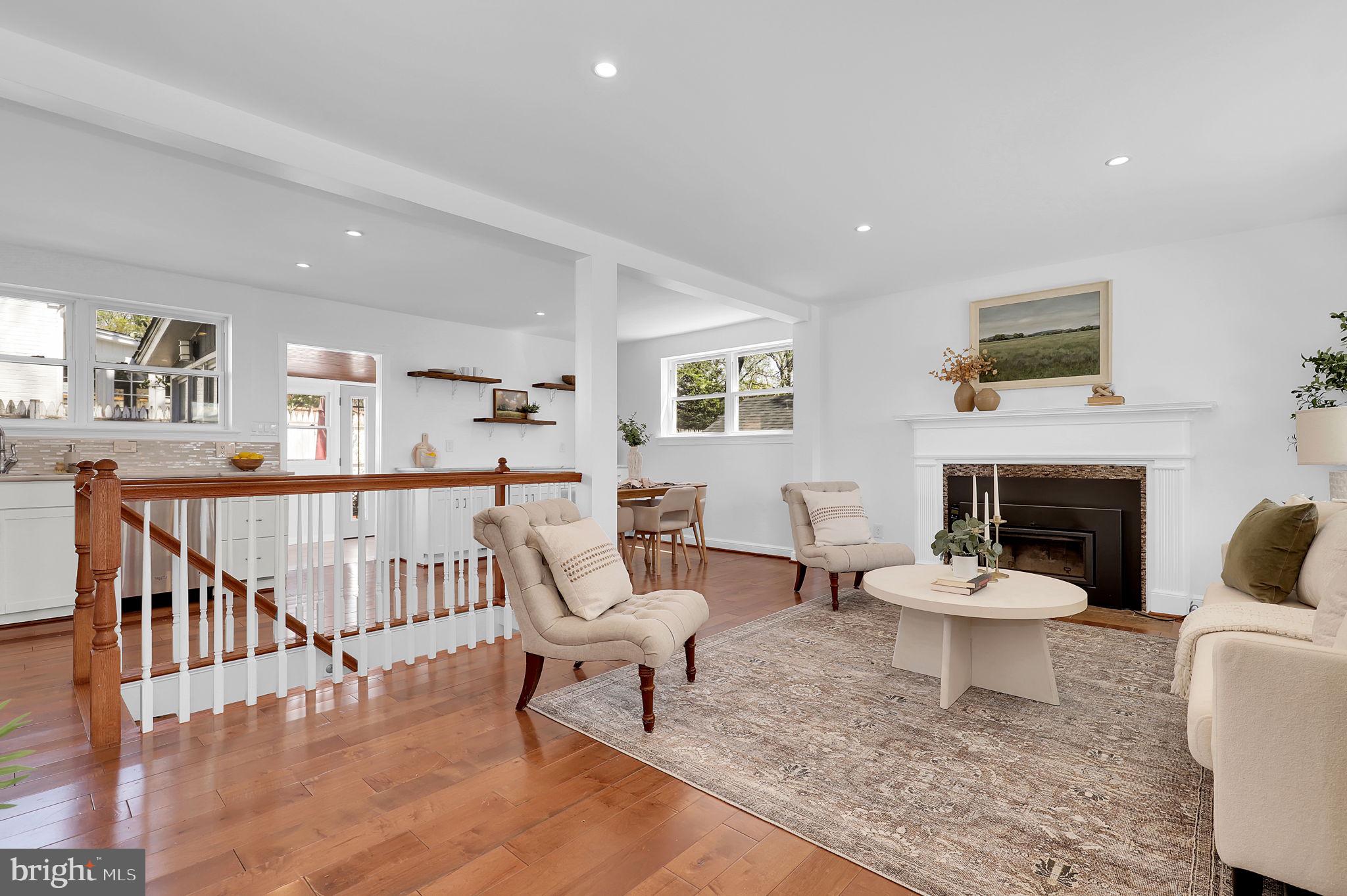 1009 Stirling Road Silver Spring, MD 20901 - Photo 5 of 33 a living room with furniture a fireplace and a table