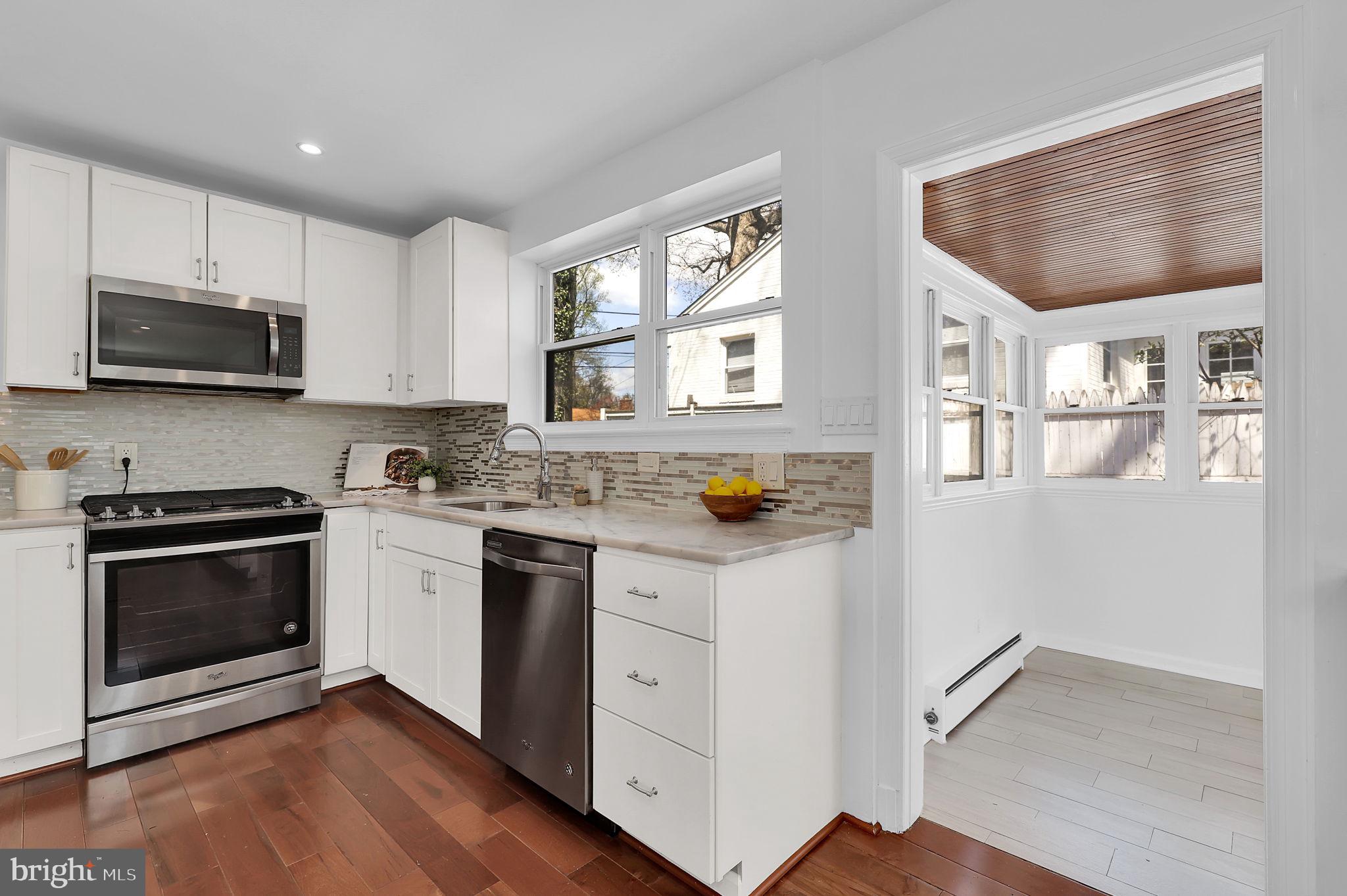 1009 Stirling Road Silver Spring, MD 20901 - Photo 10 of 33 a kitchen with stainless steel appliances granite countertop a stove a sink and a microwave