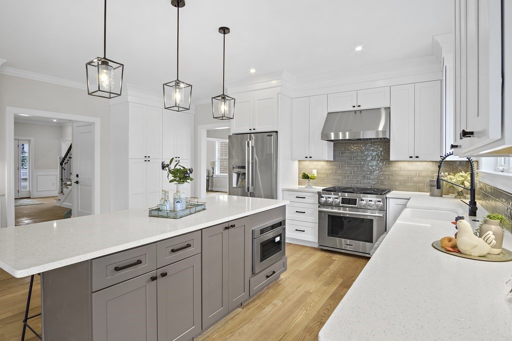 41 Peach Orchard Road Burlington, MA 01803 - Photo 14 of 42 a kitchen with stainless steel appliances granite countertop a sink a stove and a wooden floor