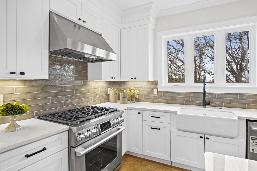 41 Peach Orchard Road Burlington, MA 01803 - Photo 15 of 42 a kitchen with granite countertop a stove and white cabinets