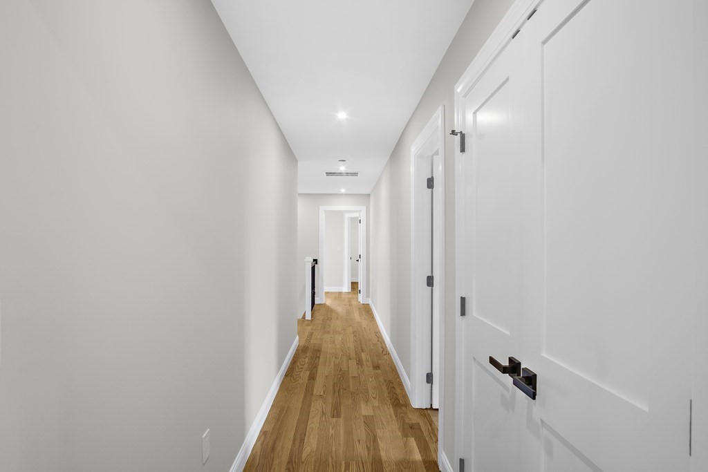 41 Peach Orchard Road Burlington, MA 01803 - Photo 27 of 42 a view of a hallway with wooden floor and staircase
