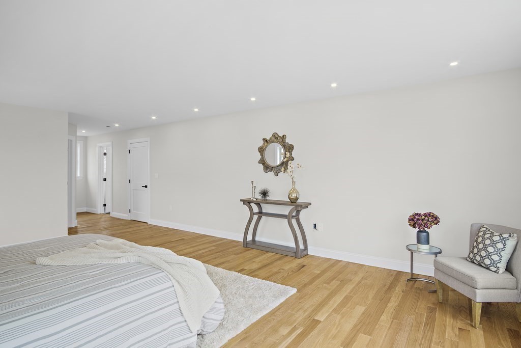 41 Peach Orchard Road Burlington, MA 01803 - Photo 30 of 42 a bedroom with a bed and a table in it