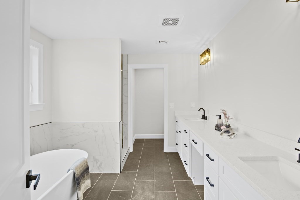 41 Peach Orchard Road Burlington, MA 01803 - Photo 31 of 42 a bathroom with a bathtub and a sink