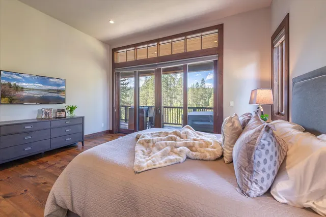 a bedroom with a bed window and a dresser