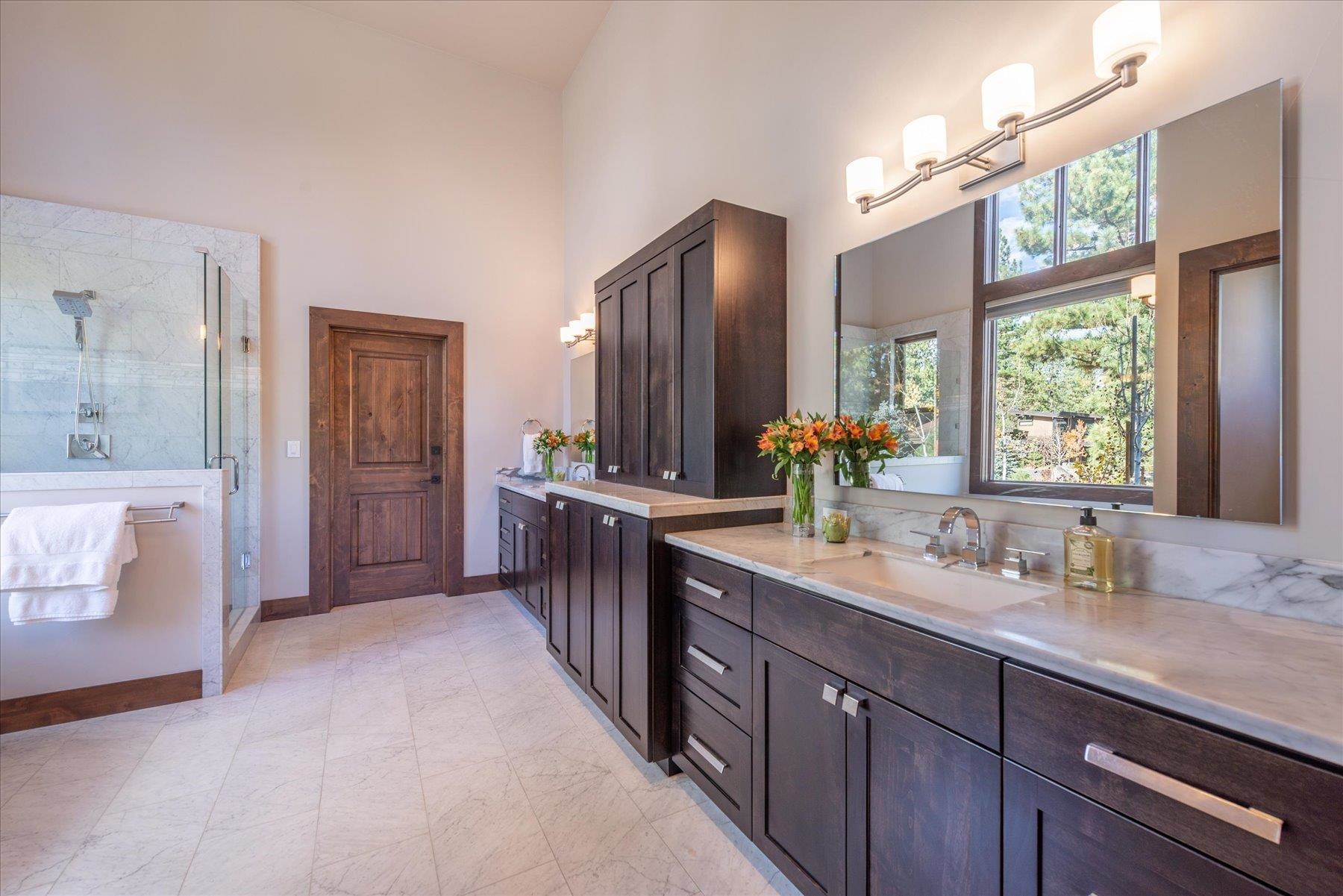 11102 Meek Court Truckee, CA 96161 - Photo 14 of 28 a spacious bathroom with a double vanity sink a mirror and a shower