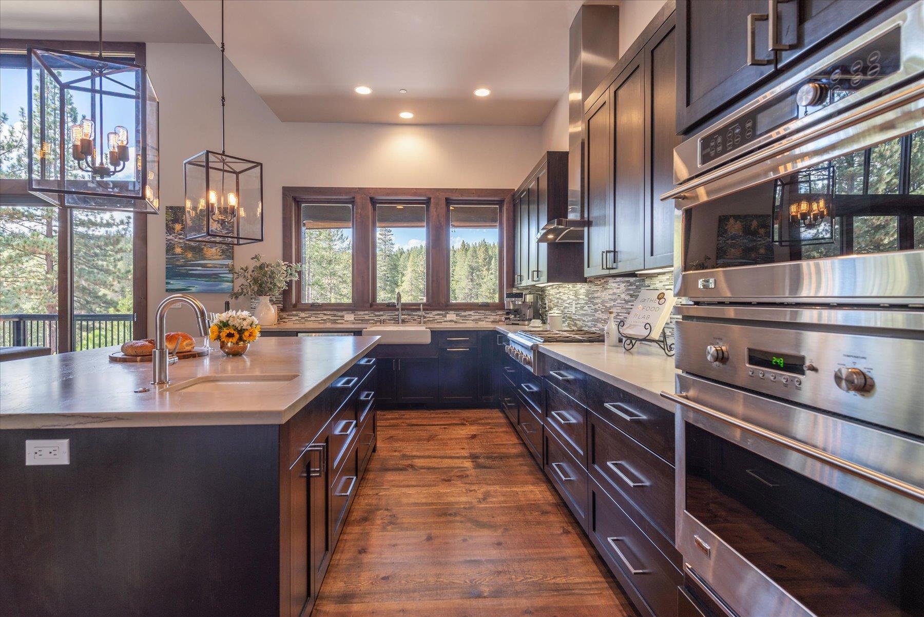 11102 Meek Court Truckee, CA 96161 - Photo 7 of 28 a large kitchen with stainless steel appliances a sink stove and cabinets