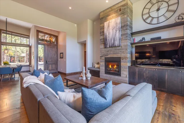 a living room with furniture a fireplace and a flat screen tv