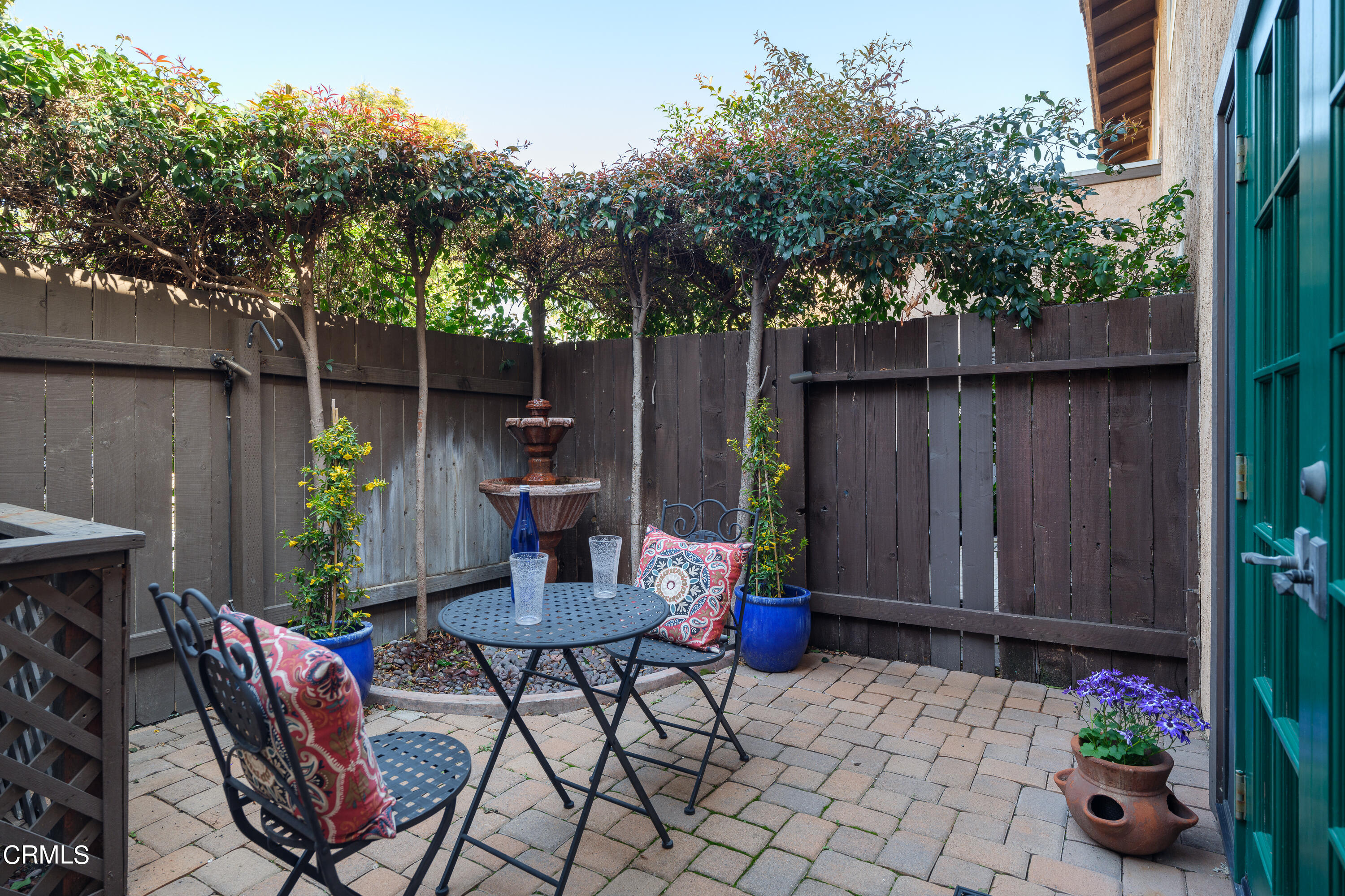 1102 Cll Adra Duarte, CA 91010 - Photo 22 of 37 a backyard of a house with table and chairs potted plants and wooden fence