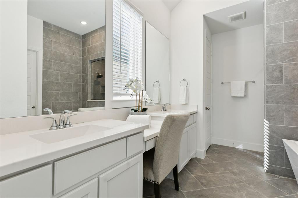 1903 Midhurst Drive Forney, TX 75126 - Photo 15 of 31 a bathroom with double vanity sinks and a mirror