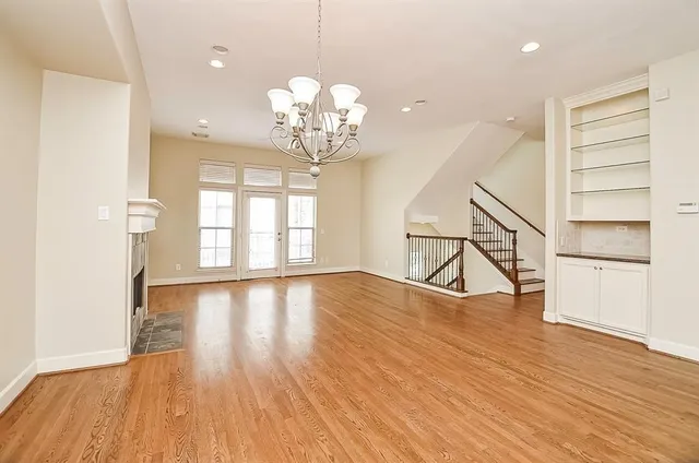 a view of a room with wooden floors and stairs
