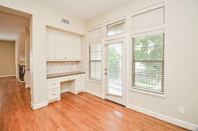 a room with a hardwood floor and a window