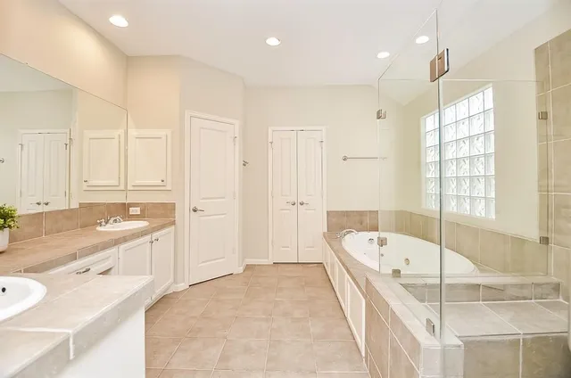 a bathroom with a tub and a shower