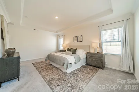 a bedroom with a bed and a couch