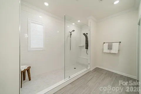 a bathroom with a shower and a glass door