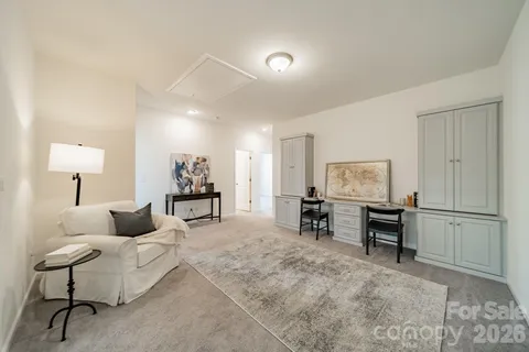 a living room with furniture and a dining table with wooden floor