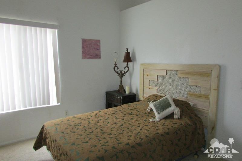 68786 Ocotillo Road Cathedral City, CA 92234 - Photo 13 of 32 a bed sitting in a bedroom next to a window