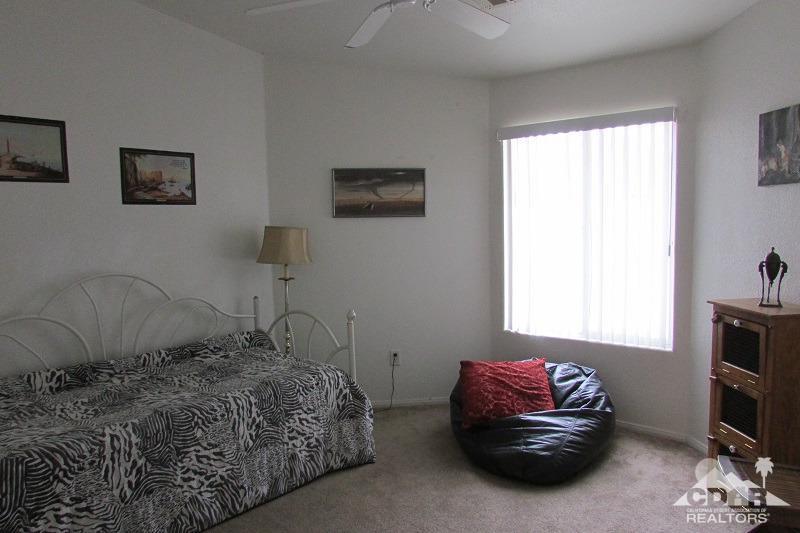 68786 Ocotillo Road Cathedral City, CA 92234 - Photo 14 of 32 a bedroom with a bed and a chair
