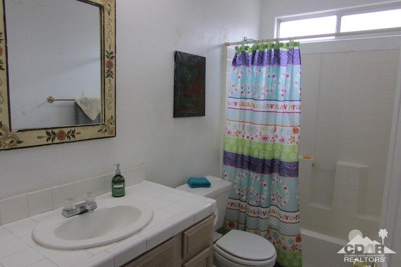 68786 Ocotillo Road Cathedral City, CA 92234 - Photo 15 of 32 a bathroom with a sink toilet and shower