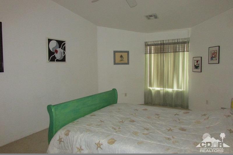 68786 Ocotillo Road Cathedral City, CA 92234 - Photo 17 of 32 a bedroom with a bed and a window