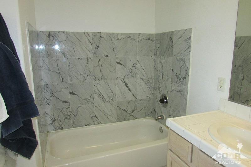 68786 Ocotillo Road Cathedral City, CA 92234 - Photo 18 of 32 a bathroom with a bathtub and shower