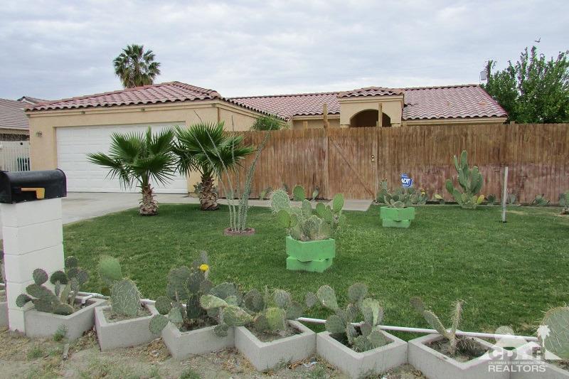 68786 Ocotillo Road Cathedral City, CA 92234 - Photo 25 of 32 a view of a backyard with plants and a fountain