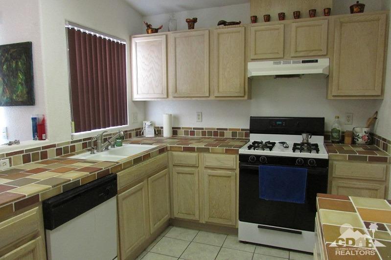 68786 Ocotillo Road Cathedral City, CA 92234 - Photo 8 of 32 a kitchen with stainless steel appliances granite countertop a sink stove and cabinets