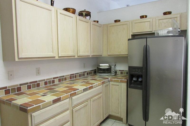68786 Ocotillo Road Cathedral City, CA 92234 - Photo 9 of 32 a kitchen with stainless steel appliances granite countertop a refrigerator and a sink