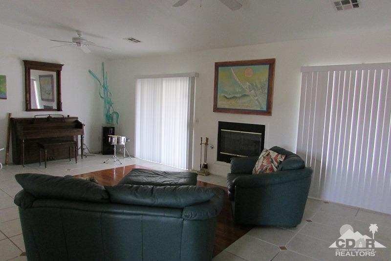 68786 Ocotillo Road Cathedral City, CA 92234 - Photo 10 of 32 a living room with furniture and a fireplace