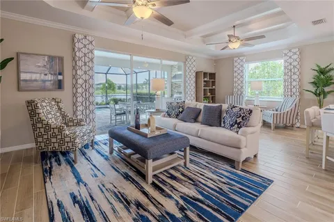 a living room with furniture a table and a large window