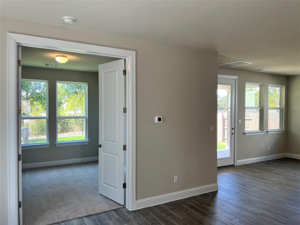 128 Free Stone Drive Georgetown, TX 78628 - Photo 5 of 29 Interior featuring wood-finish flooring, neutral wall tones, white trim, and a glass-paneled exterior door