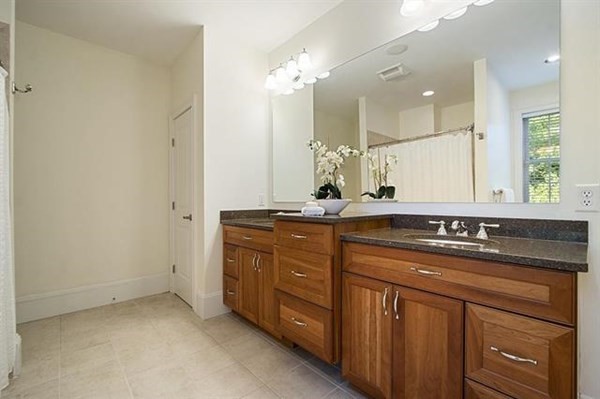 23 Pope Road Atkinson, NH 03811 - Photo 21 of 40 a bathroom with a granite countertop sink a large mirror and a