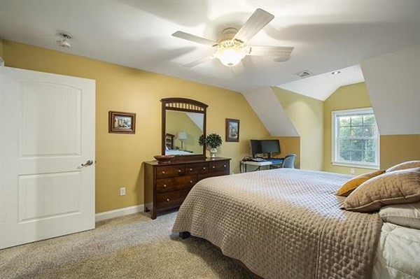 23 Pope Road Atkinson, NH 03811 - Photo 25 of 40 a bedroom with a bed and a chandelier