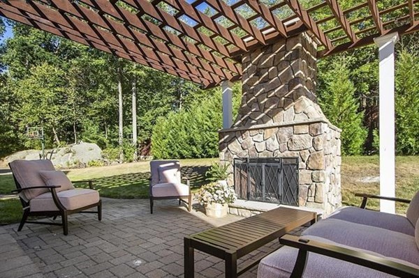 23 Pope Road Atkinson, NH 03811 - Photo 36 of 40 a view of a patio with table and chairs with wooden floor and fence