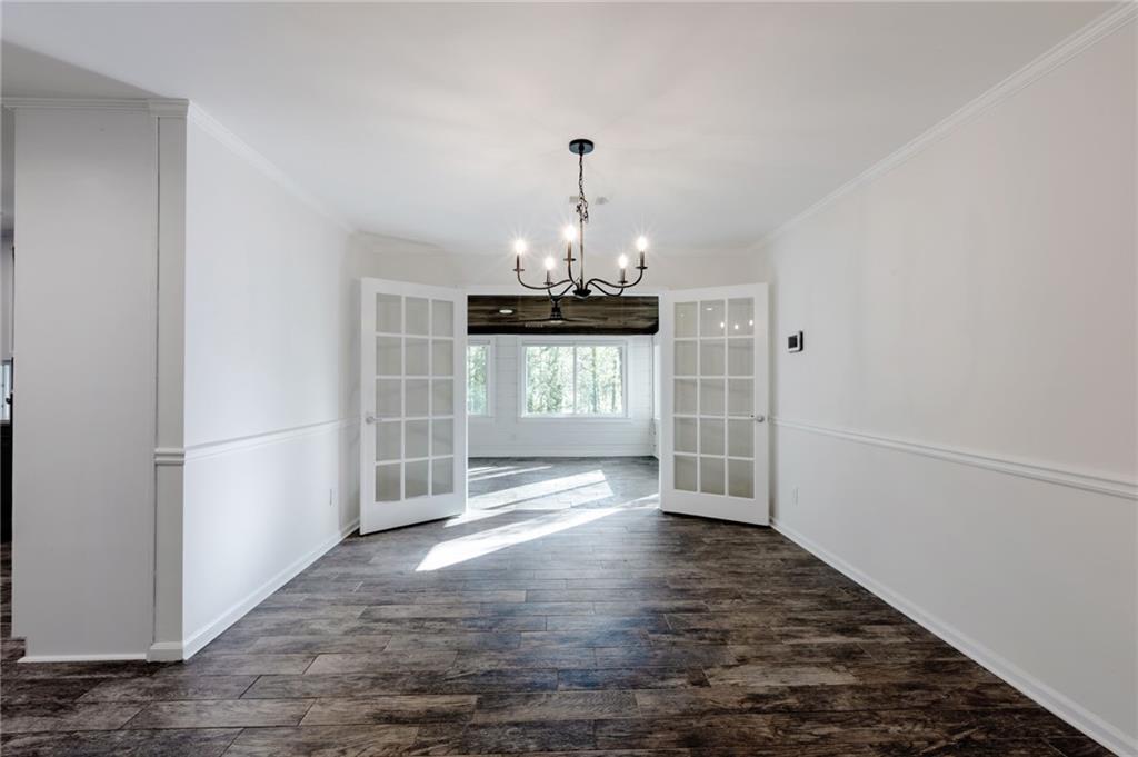 143 Swanson Road Fayetteville, GA 30214 - Photo 9 of 27 a view of an empty room with window and wooden floor