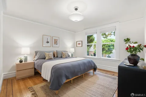 a bed room with a bed and a large window
