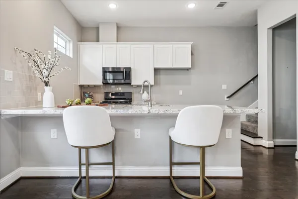 a kitchen with table chair and wooden floor