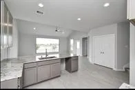 a large white kitchen with a large window