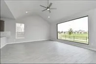 an empty room with windows and city view