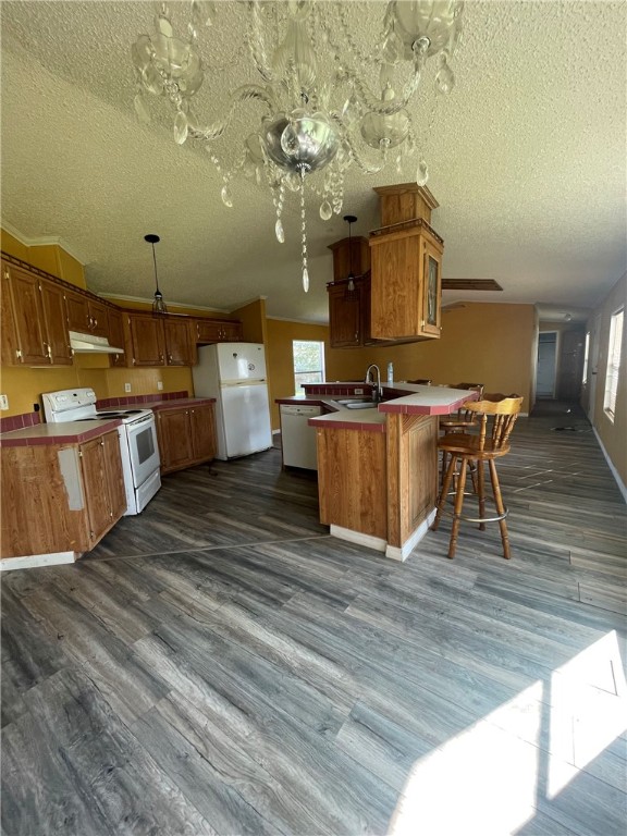 160 Ranger Drive Sandia, TX 78383 - Photo 4 of 11 a kitchen with stainless steel appliances wooden floor dining table chairs and granite counter tops