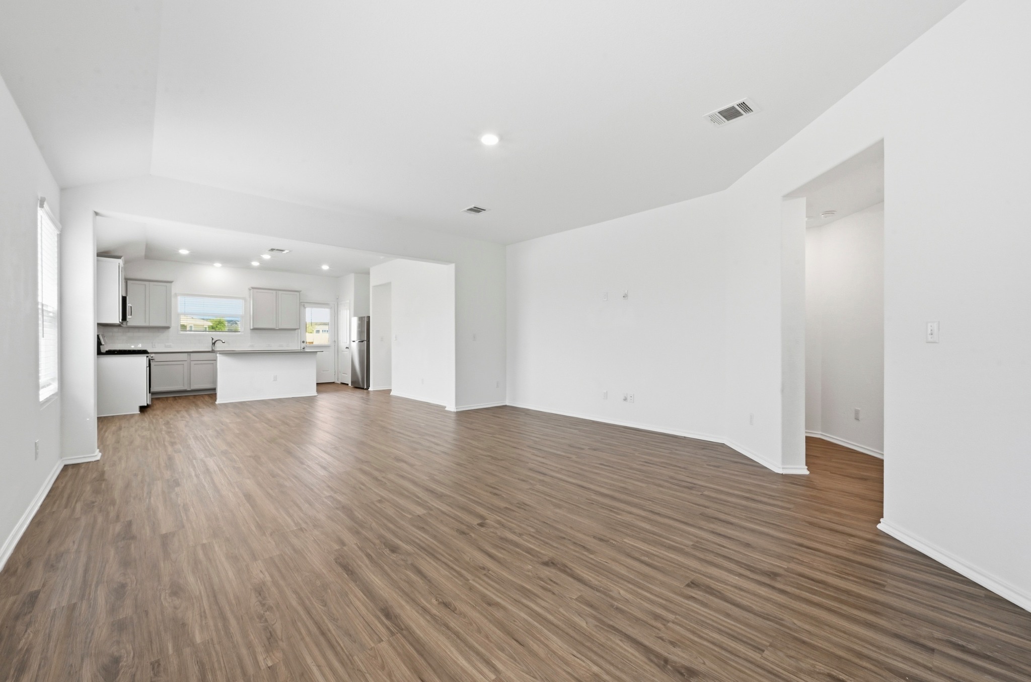 388 Barcelona Kyle, TX 78640 - Photo 4 of 26 a view of kitchen with wooden floor and a window