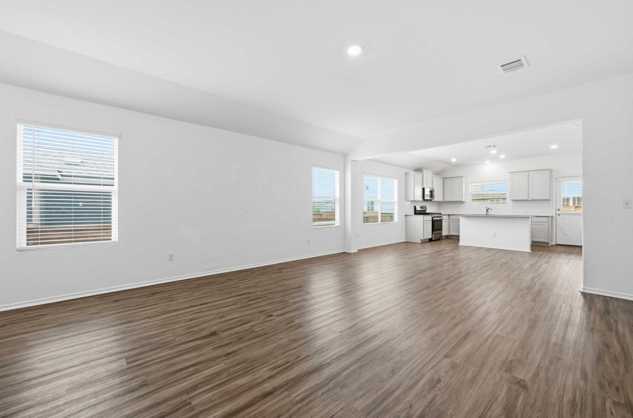 388 Barcelona Kyle, TX 78640 - Photo 5 of 26 a view of kitchen and hall with wooden floor