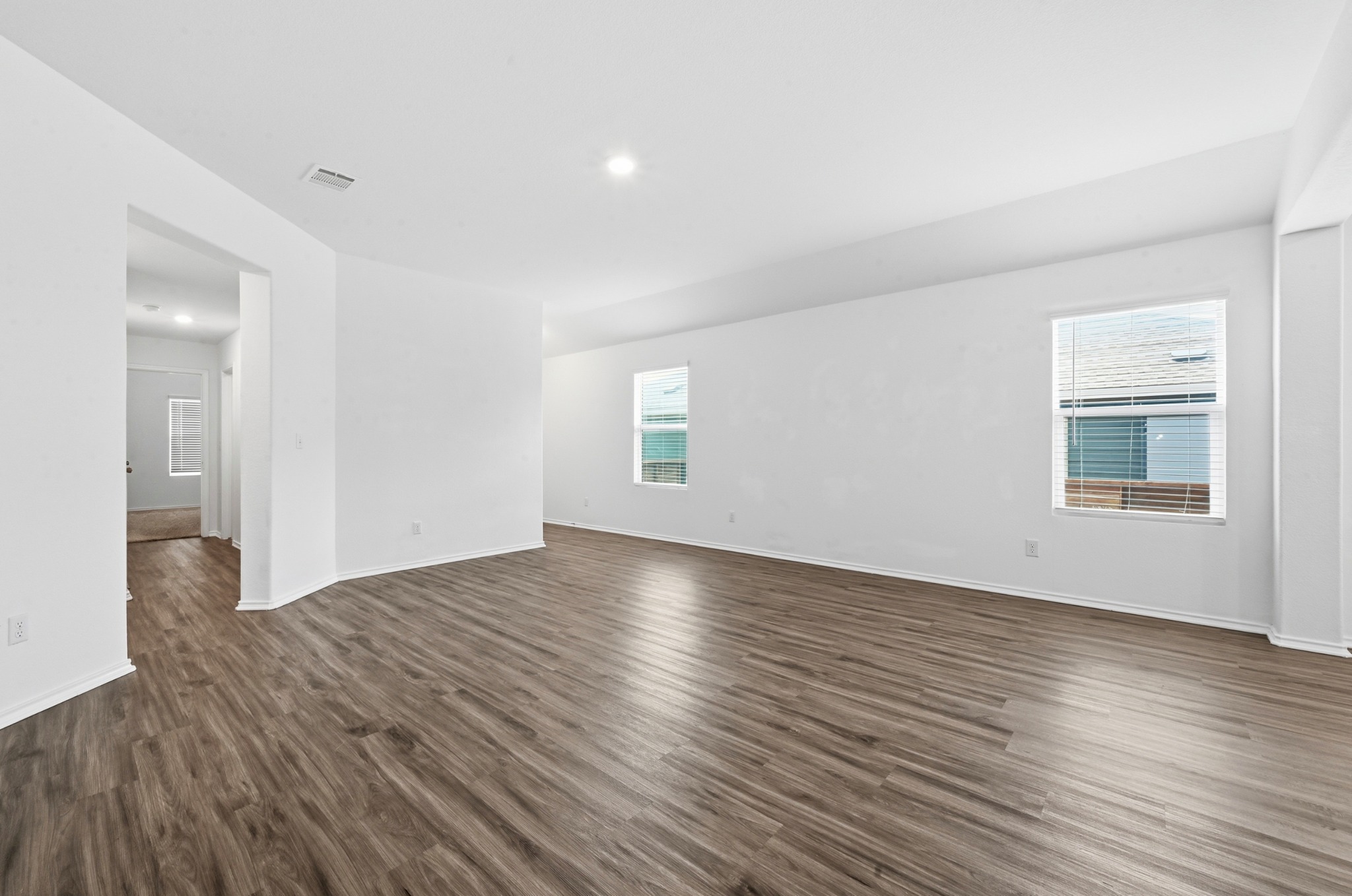 388 Barcelona Kyle, TX 78640 - Photo 6 of 26 a view of an empty room with wooden floor and a window