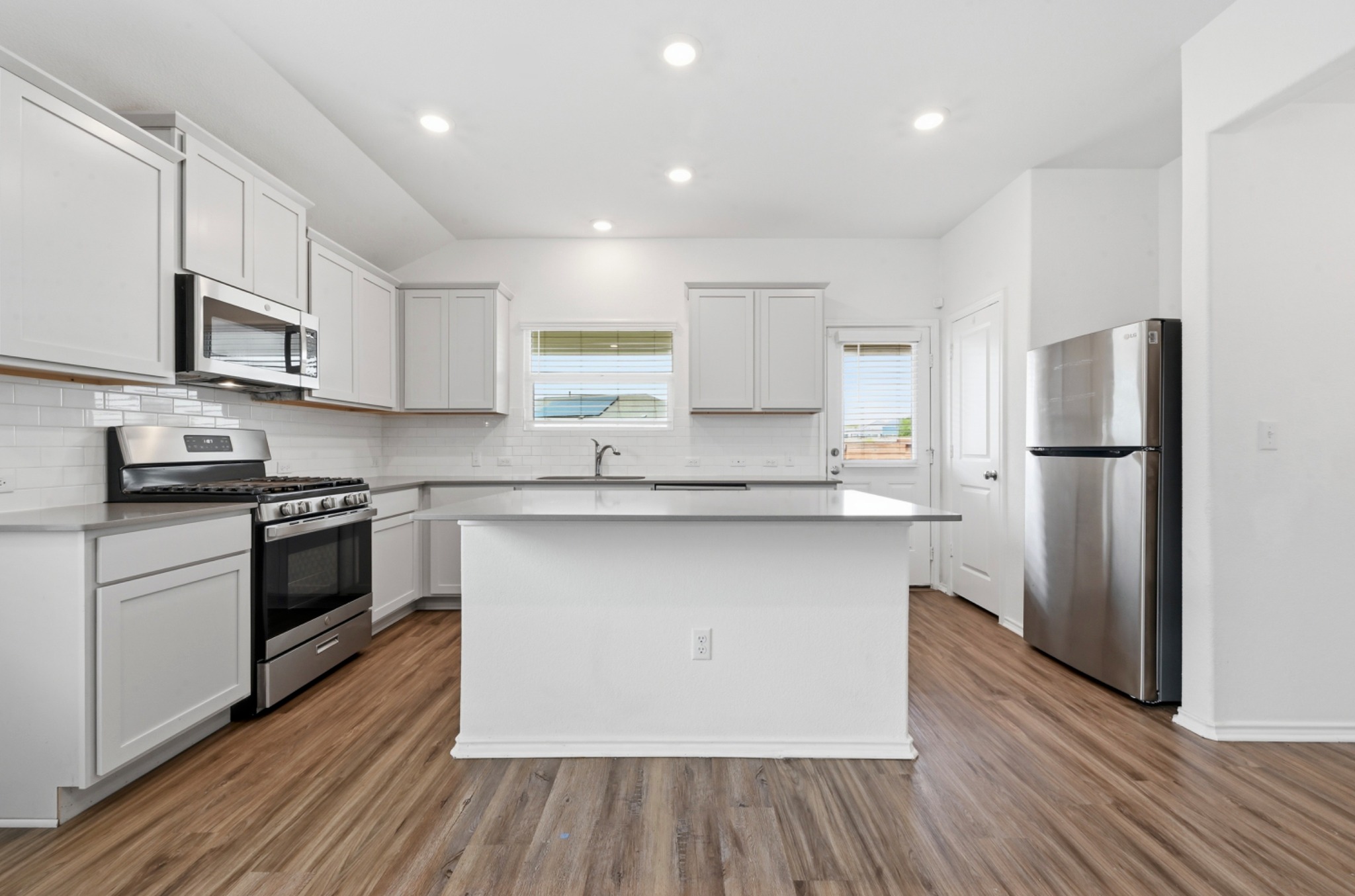388 Barcelona Kyle, TX 78640 - Photo 9 of 26 a kitchen with stainless steel appliances a refrigerator sink and microwave