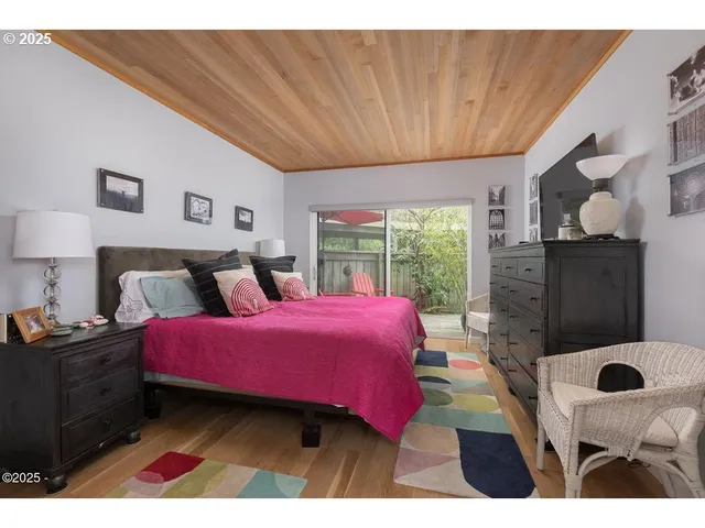 a bedroom with a bed window and lamp