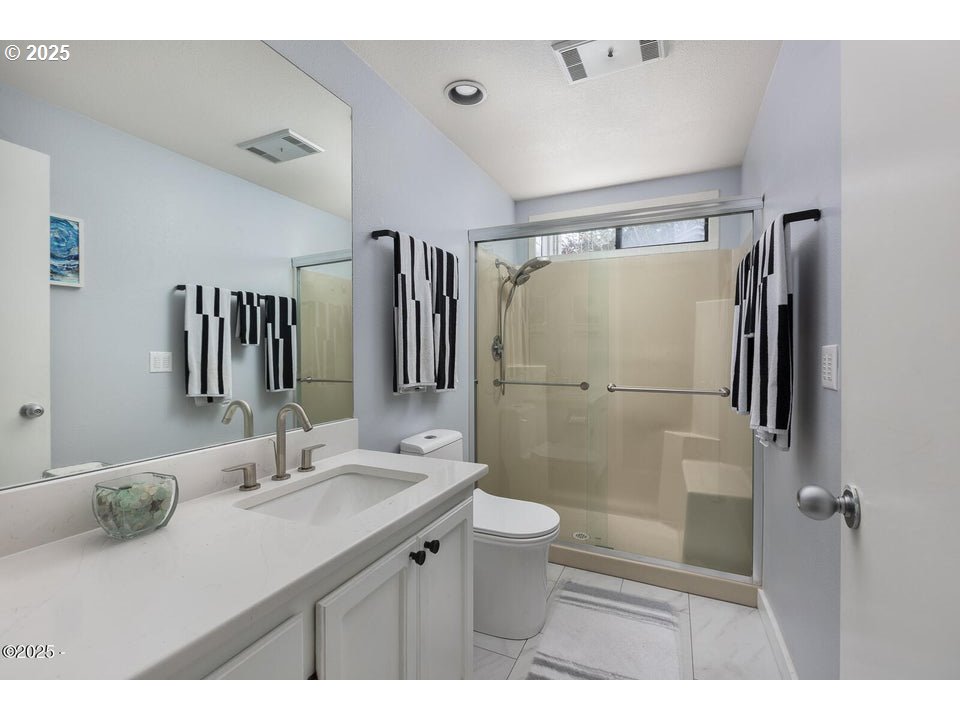4175 Highway 101, Unit A1 Depoe Bay, OR 97341 - Photo 18 of 29 a bathroom with a sink mirror toilet and shower