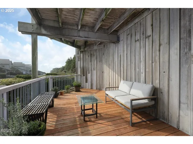 a balcony with wooden floor outdoor seating and city view