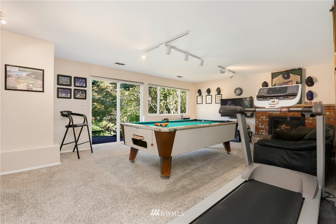 1810 234th Place Southwest Bothell, WA 98021 - Photo 22 of 36 a room with furniture and a fireplace
