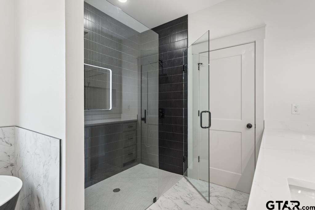 15837 Stillwaters Lindale, TX 75771 - Photo 20 of 32 a bathroom with a shower and a sink
