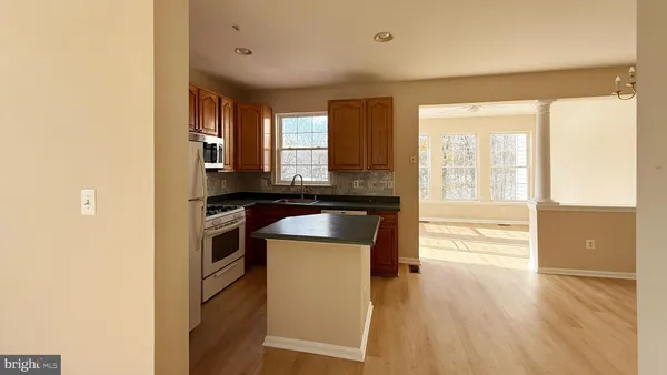 a kitchen with a refrigerator and a stove